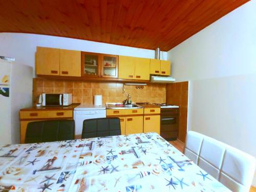 a small kitchen with a table and a kitchen with a kitchen gmaxwell gmaxwell at Apartman Arija-Pino in Vodice