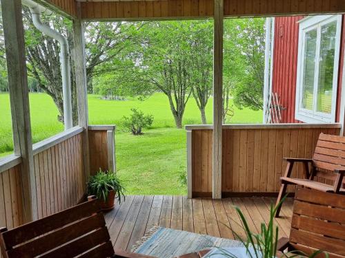 a porch with a bench and a view of a field at 4 person holiday home in J RVS in Järvsö