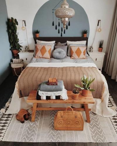 a bedroom with a large bed with a wooden table at Art riad mazighen in El Jadida