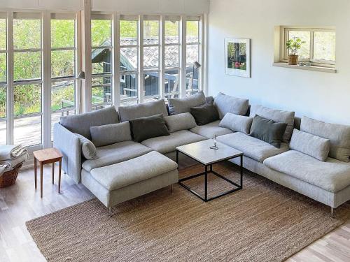 a living room with a couch and a table at 6 person holiday home in Alling bro in Allingåbro