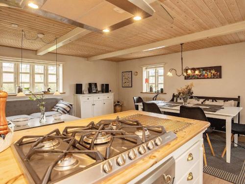 a kitchen with a stove top oven in a room at 5 person holiday home in Øster Assels-By Traum in Øster Assels