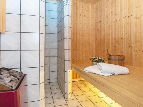 a sauna with two towels on a wooden floor at Five-Bedroom Holiday home in Fårvang 1 in Fårvang