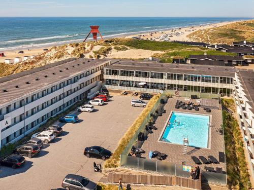 an aerial view of a hotel with a pool and the beach at 4 person apartment in holiday park Blokhus in Blokhus