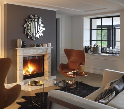 
a living room filled with furniture and a fireplace at Das Tegernsee in Tegernsee

