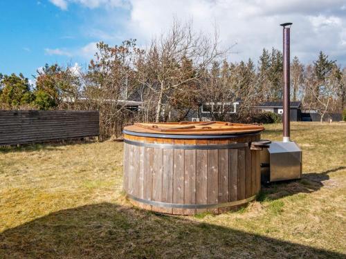 a large wooden tub sitting in a field at 6 person holiday home in Løgstør-By Traum in Løgsted