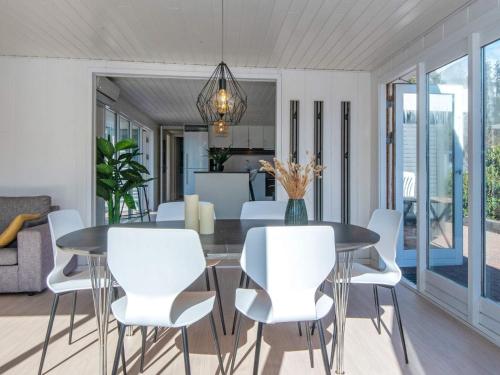 a dining room with a table and white chairs at 6 person holiday home in Løgstør-By Traum in Løgsted
