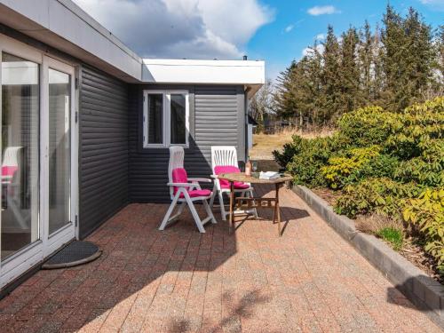 a patio with two chairs and a table at 6 person holiday home in Løgstør-By Traum in Løgsted