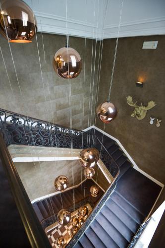 a set of stairs with copper pendant lights at Domaine de Ronchinne - Château et Ecuries in Maillen