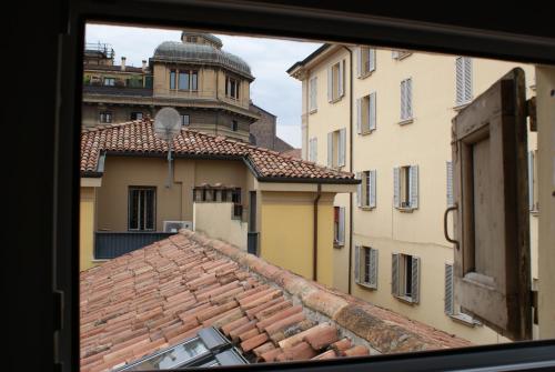 a view from a window of a tile roof at 4-Tourist House Bologna-Studio - Self check-in in Bologna