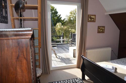 a room with a door leading to a balcony at Hotel De Waag in Bergen