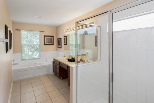 a bathroom with a shower and a sink at Spacious 6BR Villa Pool Parking Near Disney World in Orlando