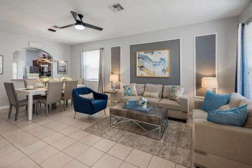a living room with a couch and a table at Spacious 6BR Villa Pool Parking Near Disney World in Orlando