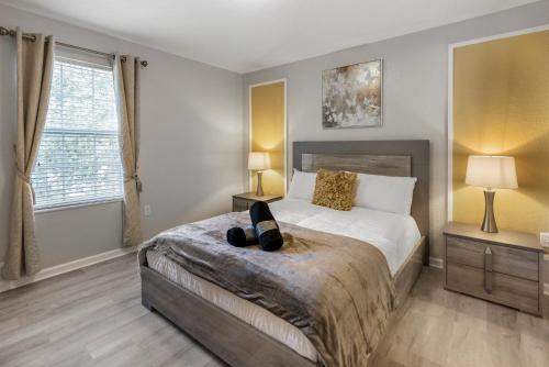 a bedroom with a bed with two lamps on it at Spacious 6BR Villa Pool Parking Near Disney World in Orlando