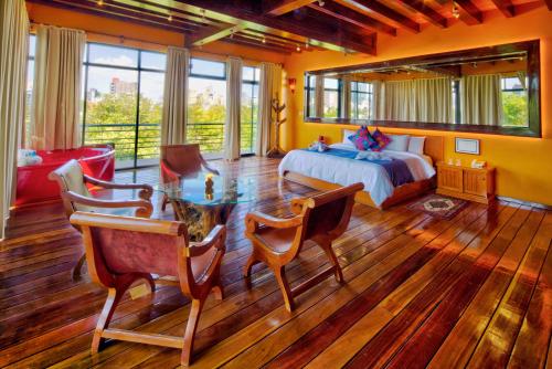Hotel Parque España في مدينة ميكسيكو: غرفة نوم بسرير وطاولة وكراسي