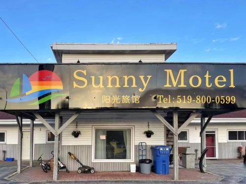 a sign for a sunny motel on the side of a building at Sunny Motel Port Elgin in Port Elgin