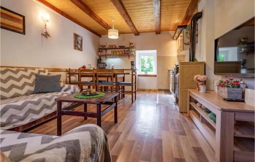 a living room with a couch and a table at 2 Bedroom Nice Home In Fuzine in Fužine