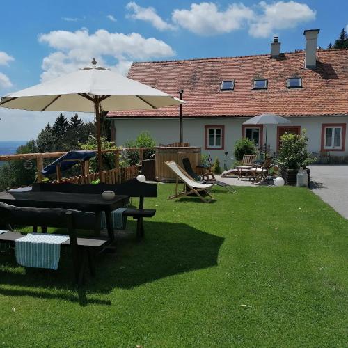 a patio with an umbrella and a table and chairs at Apartment Schloffer in Weiz