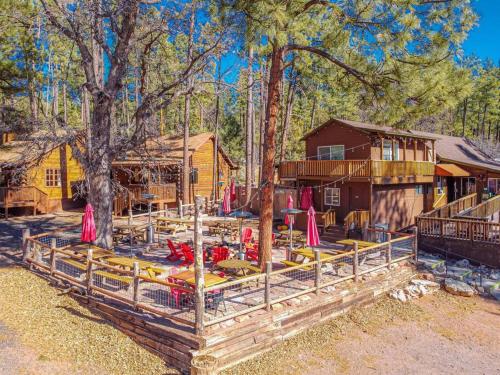 a resort with tables and chairs in front of a building at Forest Cabin 6 Enchanted Forest in Payson