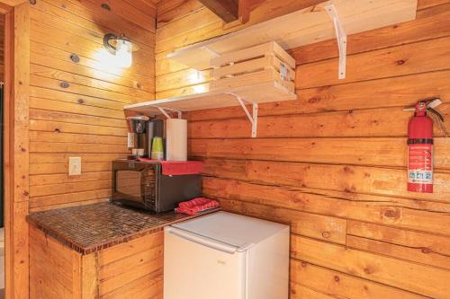 a small kitchen with a refrigerator and a microwave at Forest Cabin 4 Cowboys Dream in Payson