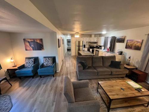 a living room with couches and a table and a kitchen at Forest Cabin 7 Seventh Heaven in Payson