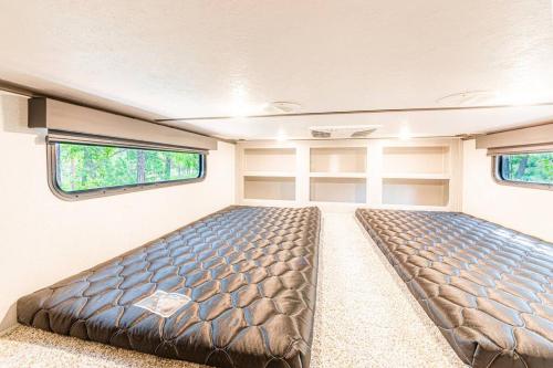 a bedroom with two beds in a trailer at Luxury Glamper Retreat 14 Forest Site in Payson
