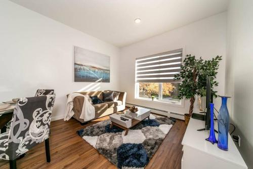 a living room with a couch and a table at Stylish Close to D/T FREE parking King Bed 2bed in Edmonton