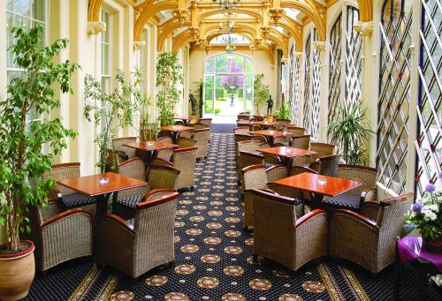 a row of tables and chairs in a restaurant at Orton Hall Hotel & Spa in Peterborough