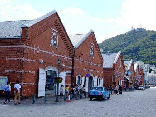 a group of people standing outside of a brick building at Hakodate Jyujiya Hotel in Hakodate
