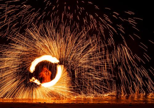 a fire show with a horse in a circle of sparks at Likuri Island Resort Fiji in Natadola