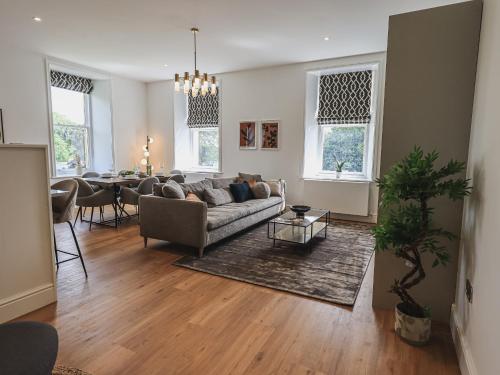 a living room with a couch and a table at The Emma Suite Stone Cross Mansion in Ulverston