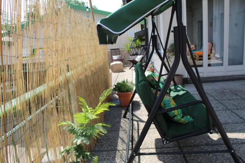 a swing set in front of a fence with plants at Appartamento con terrazza a due minuti dal lago in Minusio