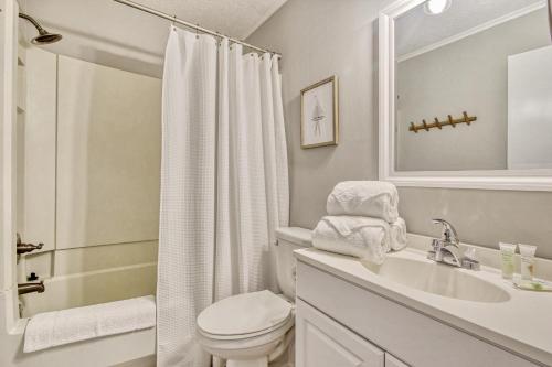 a white bathroom with a sink and a toilet at Windy Village C-6 in Myrtle Beach