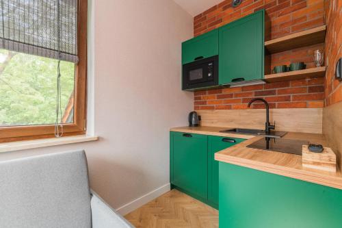 Η κουζίνα ή μικρή κουζίνα στο Apartamenty Gajówka- rowery, plac zabaw, sauna, jacuzzi