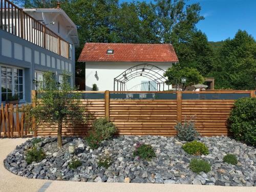 a wooden fence in front of a house at Logis Hostellerie du Neez in Gan