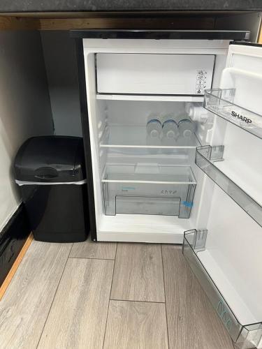 an empty refrigerator with its door open on a floor at Nuns Moor fully equipped kitchen free parking Netflix in Newcastle upon Tyne