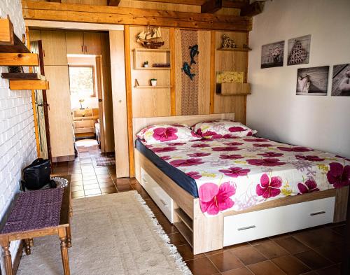 a bedroom with a bed with pink flowers on it at Hidden Gem of Krasici in Radovići