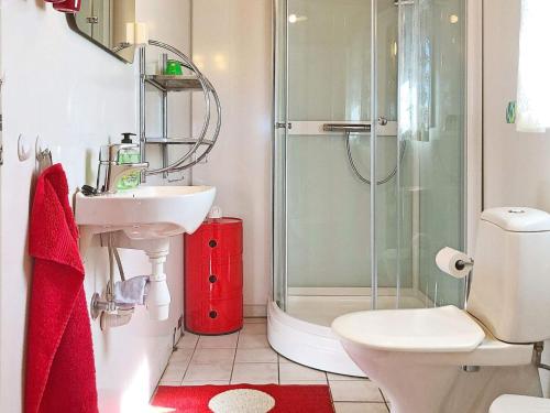 a bathroom with a shower and a toilet and a sink at 4 person holiday home in lyngdal-By Traum in Korshamn