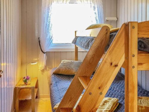a bedroom with a bunk bed with a ladder at 4 person holiday home in lyngdal-By Traum in Korshamn