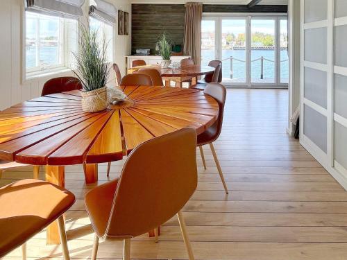 a dining room with tables and chairs and aorus at 12 person holiday home in bremnes-By Traum in Bremnes