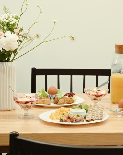 a table with two plates of food on it at Hygge Kro in Hualien City