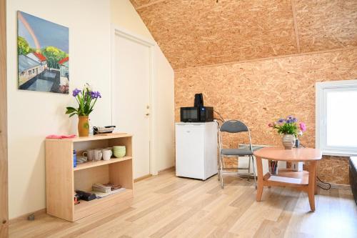 a living room with a small table and a refrigerator at Haapsalu Kunstikooli hostel in Haapsalu