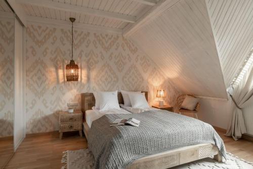 a bedroom with a large bed and a ceiling at Apart-Center Motola Residence in Zakopane