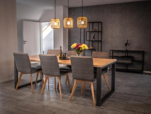 a dining room with a wooden table and chairs at Hotel Novy Kastiel - Self check-in in Topoľčany
