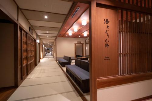 a hallway with a row of chairs in a building at Kyoto Umekoji Kadensho in Kyoto