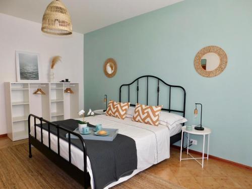 a bedroom with a bed and a table with pillows at Casa Azzurra in Marzocca di Senigallia