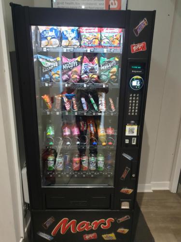 a vending machine filled with lots of snacks and drinks at JUST SLEEP Hostel in Edinburgh