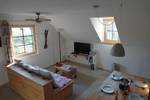 a living room with a couch and a table at Gîte La Grange in Chapelle