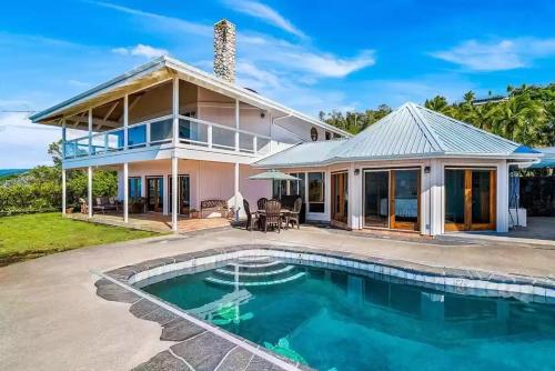 a house with a swimming pool in front of it at Luxe Designer Home, Best 180 Ocean View, Hot Tub & Pool estate in Papa Bay Estates