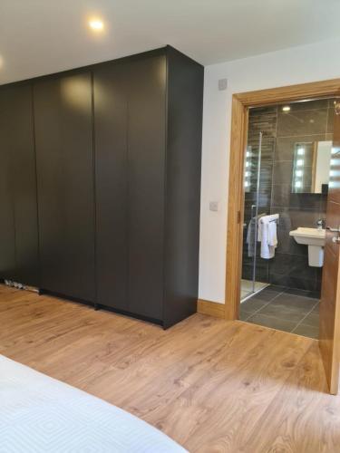 a bedroom with a large black closet at Ard Kielin Apartment Luxury 2 bedroom in Killarney in Killarney