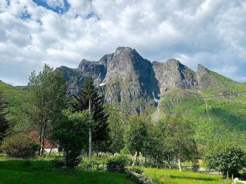 a group of mountains with trees in a field at 5 person holiday home in LAUPSTAD in Vestpollen